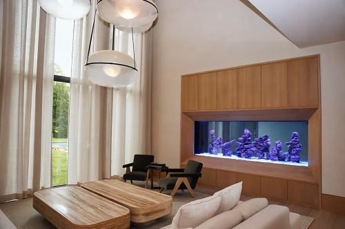 Custom 1,000-gallon saltwater reef aquarium installed in a Long Branch, New Jersey residence, designed and built as a fully integrated architectural feature.